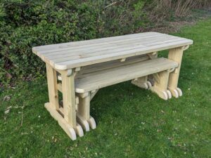 picnic table set with rounded edges, benches neatly stored underneath.
