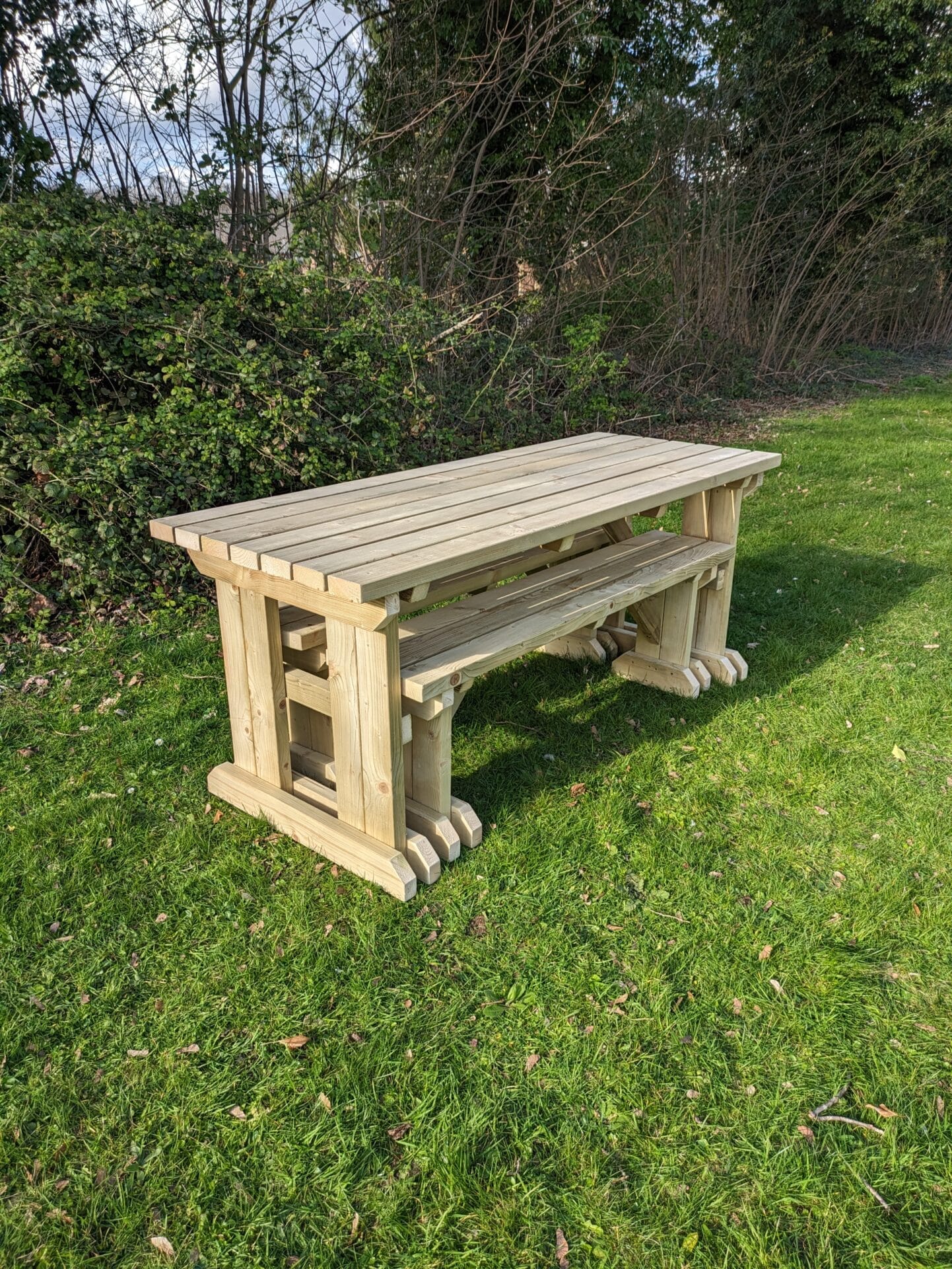 picnic table set with straight edges, benches neatly stored underneath.