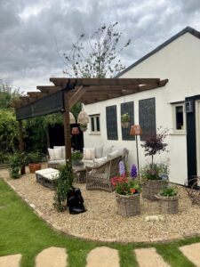 3.0m x 4.2m lean to pergola in brown timber attached to garden wall
