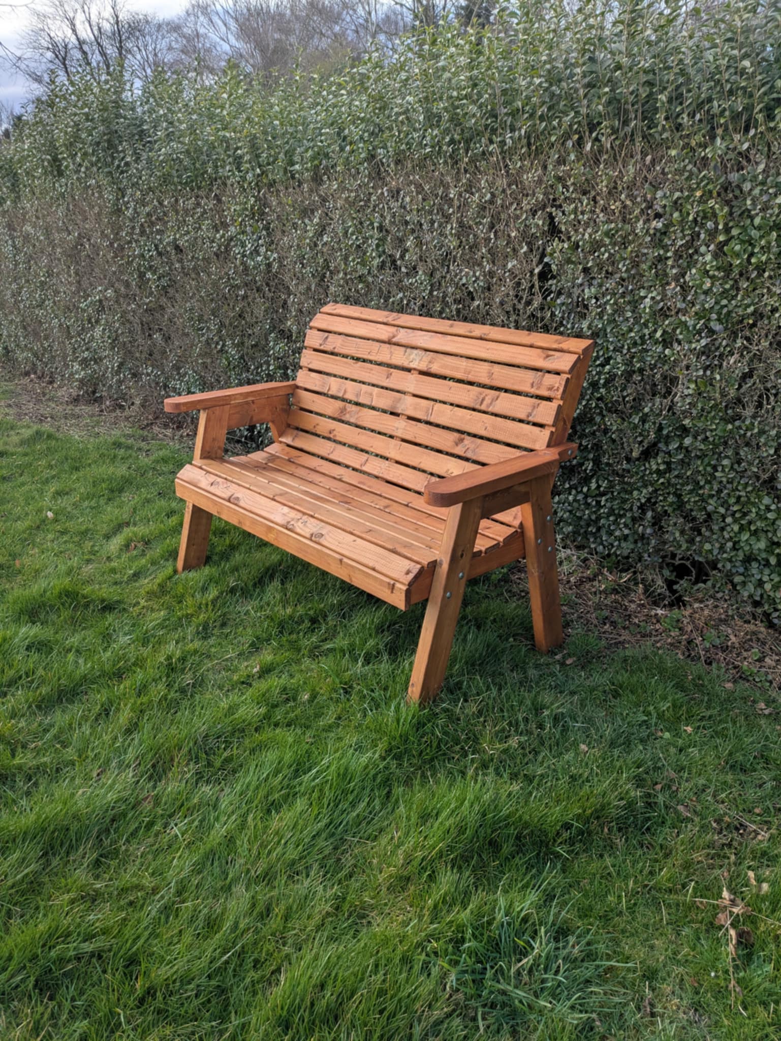 2 Seater Armchair in natural cedar, made from FSC-certified pressure-treated wood for outdoor use.