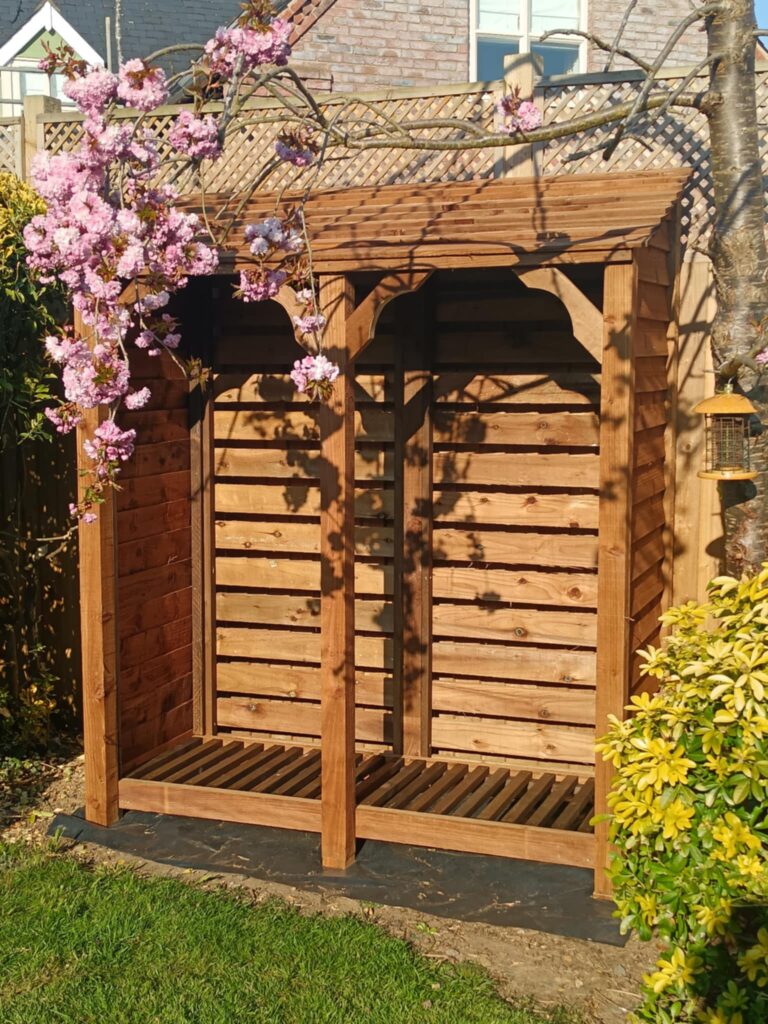 7ft tall 6ft wide Baylham log store in brown, custom-made with decorative details