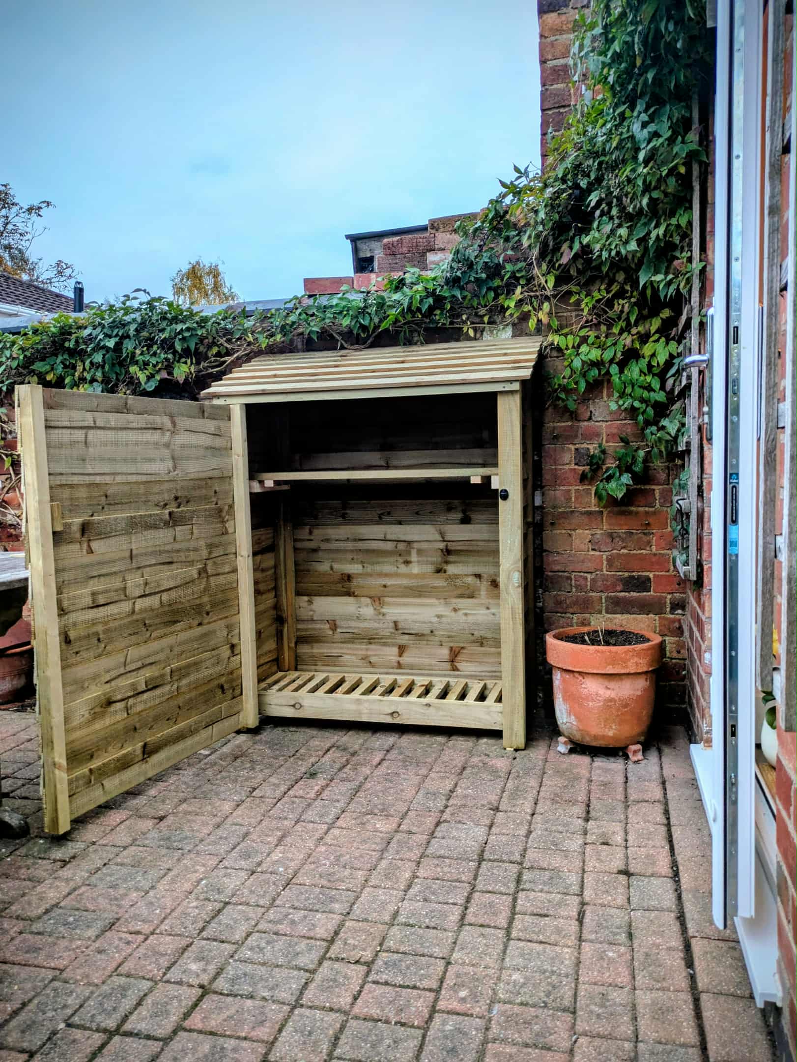 4ft compact log store with open door and shelf