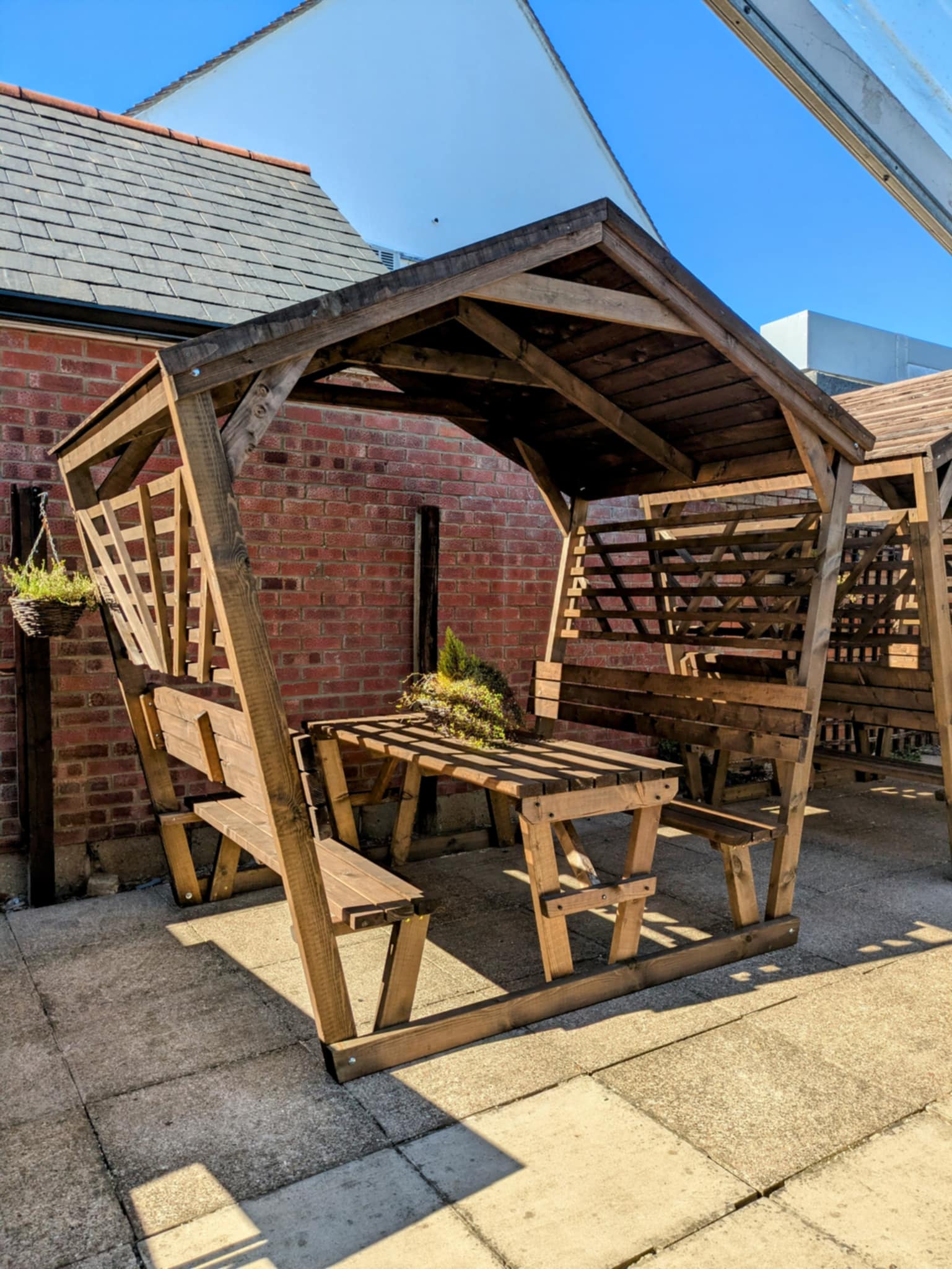 Covered picnic pod with featheredge roof photographed from the front angle