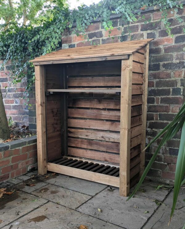 Close-up front view of 4ft compact log store with shelf in brown finish
