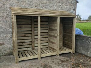 9ft deep log store with partition panel in green finish, 7ft tall